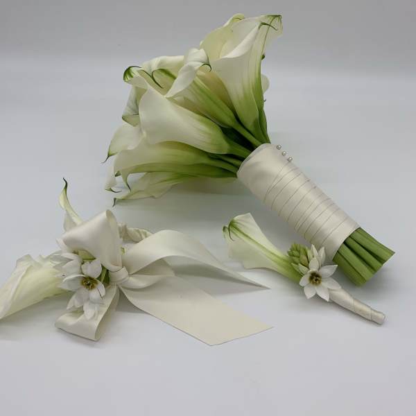 White calla lily bouquet with satin ribbon and small white flowers