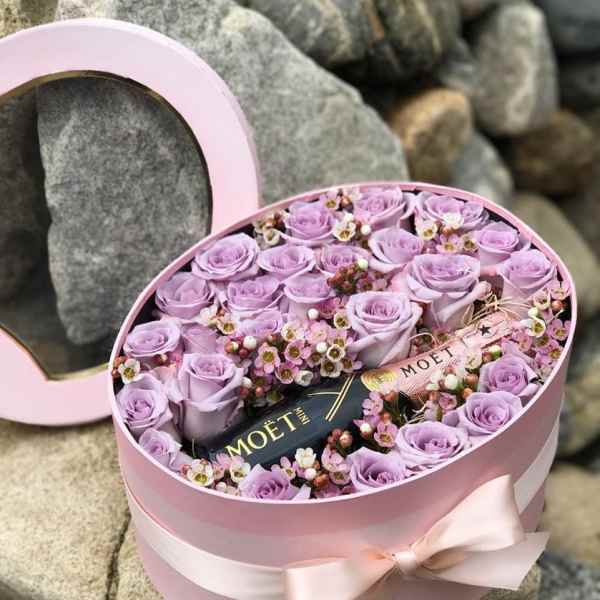 Pink hatbox with lavender roses and a Moët bottle