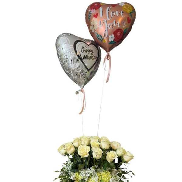 Bouquet of cream roses in a glass vase with two heart balloons