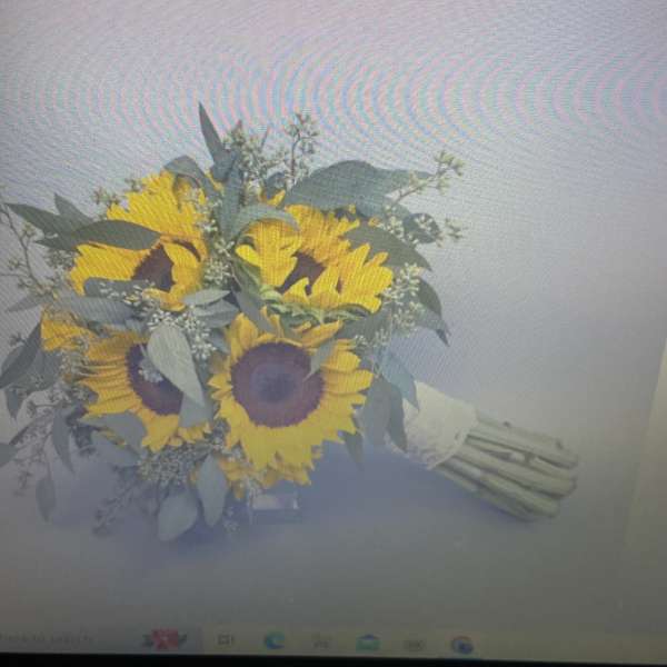 Bouquet of yellow sunflowers with pale greenery and white filler