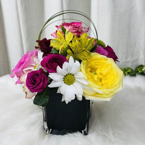 Colorful flower basket with roses, daisies, and yellow alstroemeria