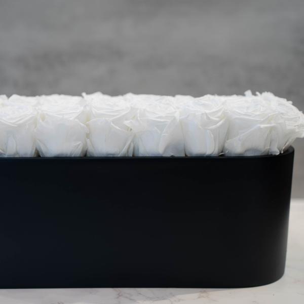 White Roses in Oval Black Container