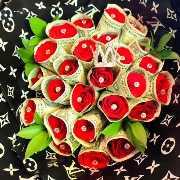 Bouquet of red roses wrapped in dollar bills with green leaves