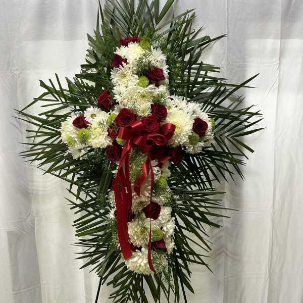 Standing floral spray with red roses and white chrysanthemums on an easel