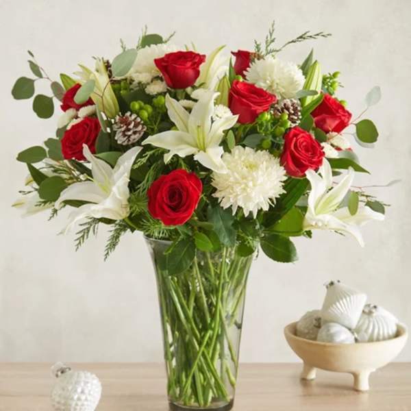 Red roses and white lilies in a clear glass vase
