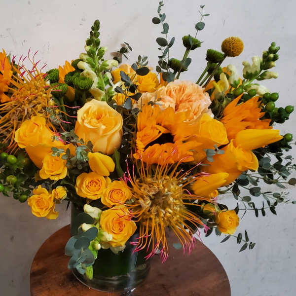 Yellow and orange mixed bouquet in a glass vase