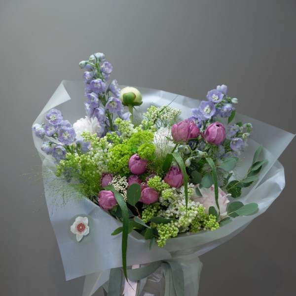 Lavender and pink bouquet in a glass vase with ribbon