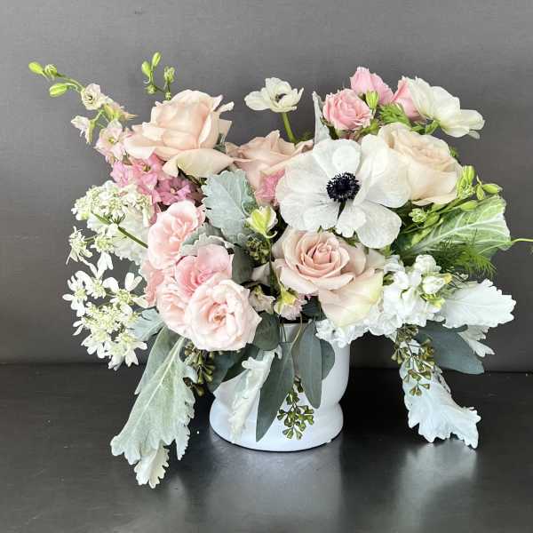 Blush and white floral arrangement in a white vase