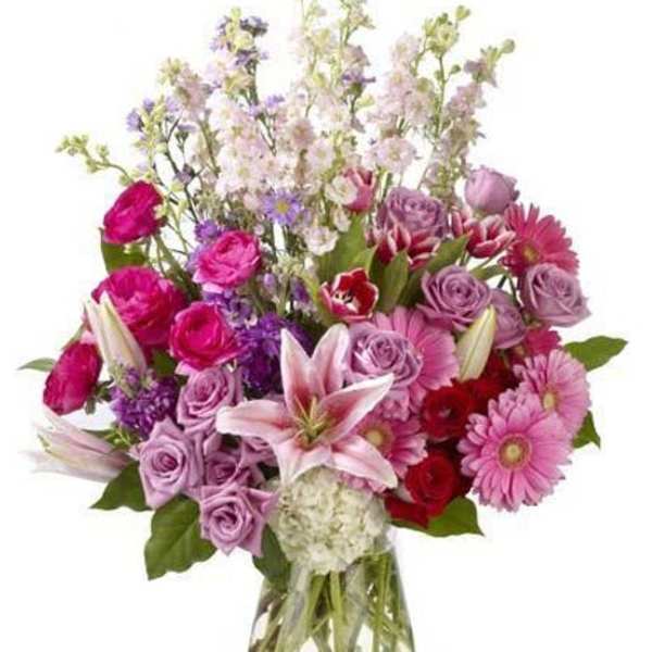 Mixed pink and purple bouquet in a clear glass vase