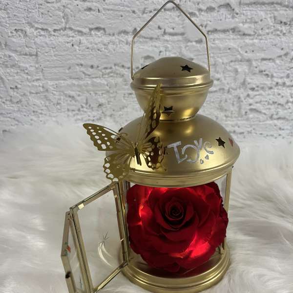 Gold lantern with a red rose inside and a butterfly decoration
