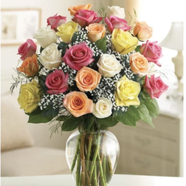 Bouquet of multicolored roses in a clear glass vase
