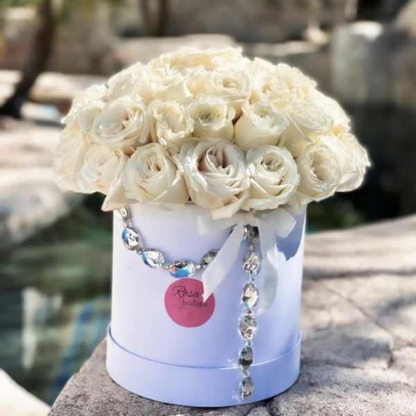 Cream rose bouquet in a white hat box with ribbon and crystal garland