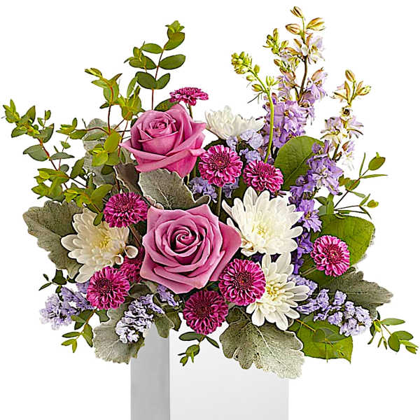 Pink roses and white daisies in a white box vase