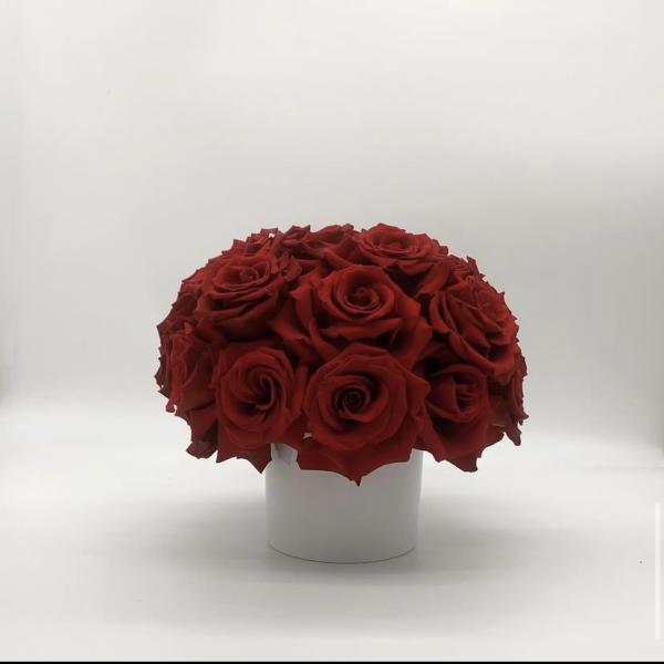 Red rose bouquet in a white cylindrical vase