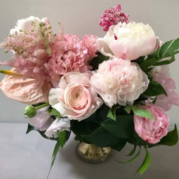 Pink and white floral arrangement in a small vase