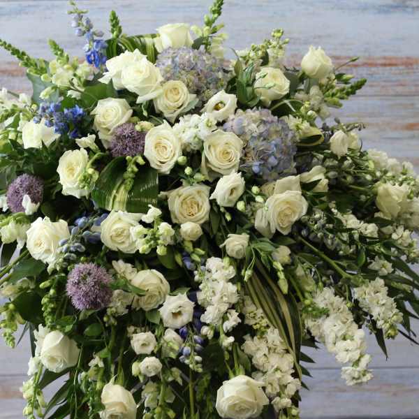Large white floral spray with roses and lavender accents