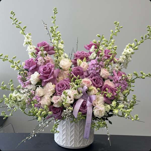 Lavender and blush roses in a white textured vase