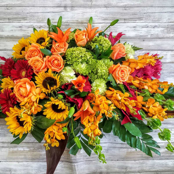 Bright mixed bouquet with roses, sunflowers, and orchids