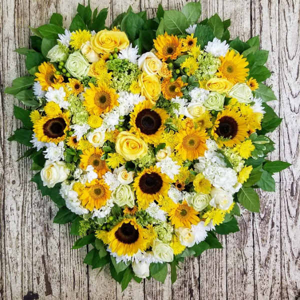 Heart-shaped bouquet of yellow sunflowers and white roses