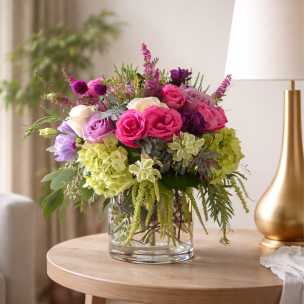 Mixed pink and purple bouquet in a clear glass vase