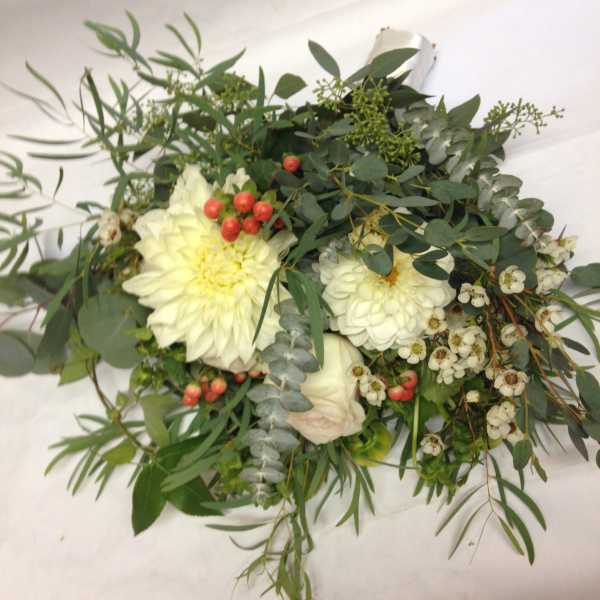 White flower bouquet with greenery and red berries