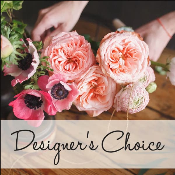 Pink and peach roses with anemones in a hand-held bouquet