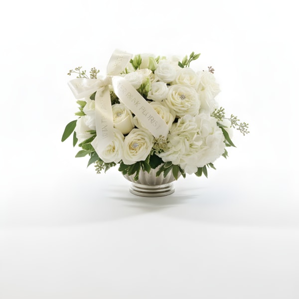 White rose bouquet in a silver vase with cream ribbons