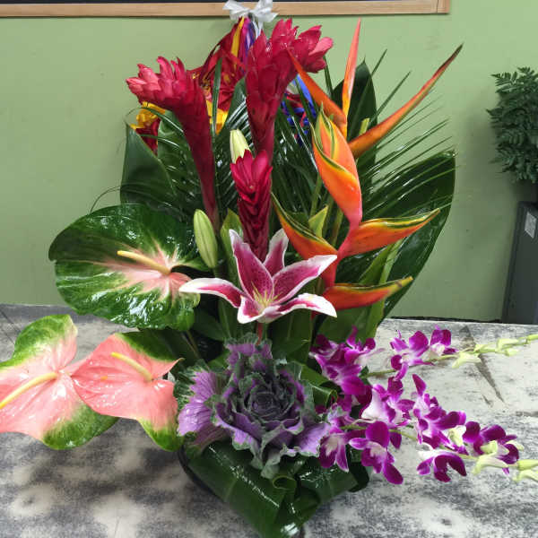Tropical flower arrangement with orchids, anthuriums, and bird of paradise
