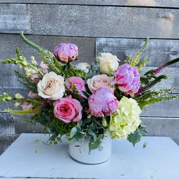 Pink and white roses with hydrangea in a white vase