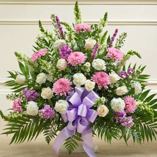 Large pink and white floral spray with a purple ribbon bow