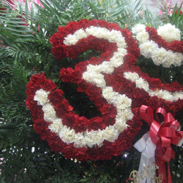 Red and white carnation arrangement shaped like a large number 3