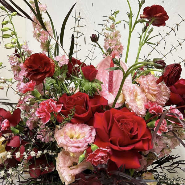 Red roses and pink carnations in a mixed bouquet with tall stems