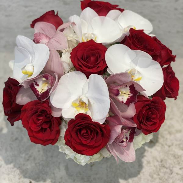 Bouquet of red roses and white orchids with pink orchids