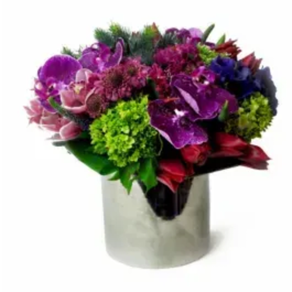Colorful bouquet of purple, pink, red, and green flowers in a white vase