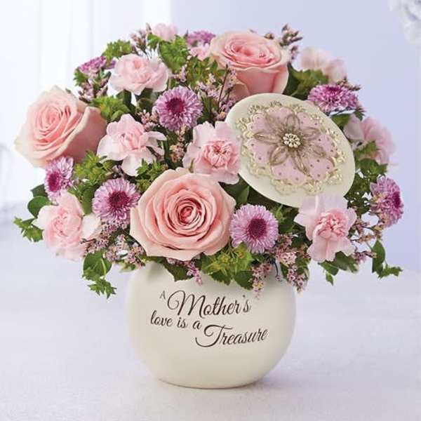 Pink roses and small purple flowers in a cream vase with a Mother's Day message
