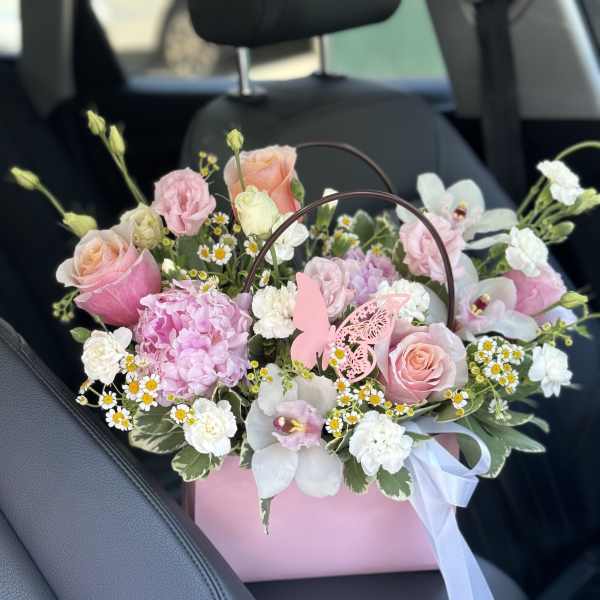 Pink and white bouquet in a pink gift box with a butterfly pick
