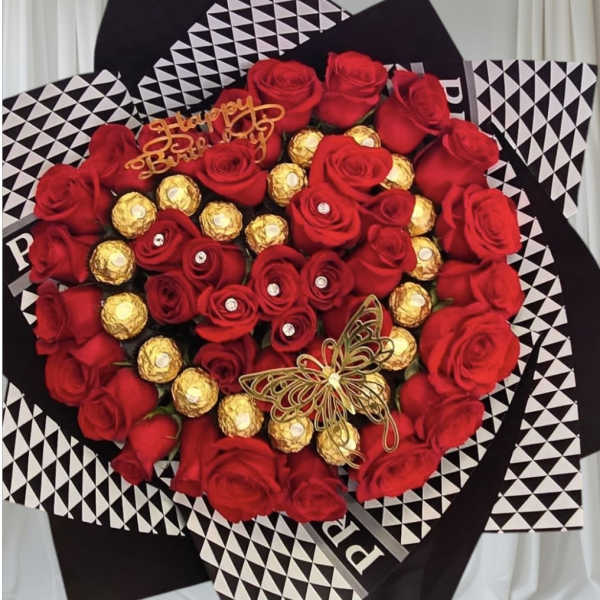 Heart-shaped bouquet of red roses and gold-wrapped chocolates