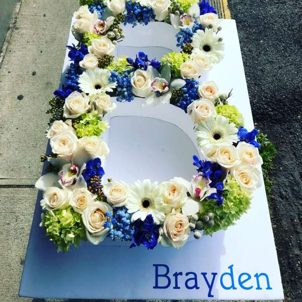Floral number 6 with white roses, daisies, and blue flowers on a sign
