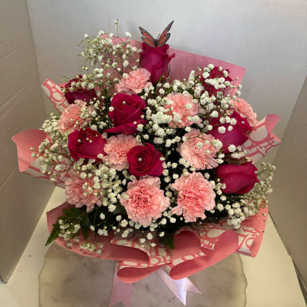 Pink and red bouquet of roses and carnations with baby's breath
