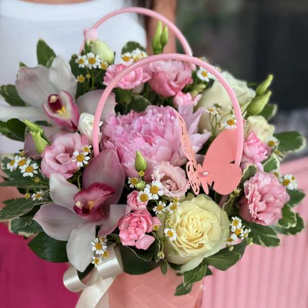Pink floral basket with roses, orchids, and daisies