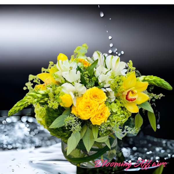 Yellow and white floral arrangement in a glass vase