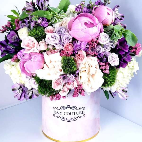Pink and purple mixed bouquet in a round hat box