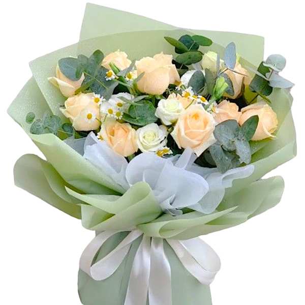 Bouquet of pale peach roses with small white daisies and eucalyptus in green wrap
