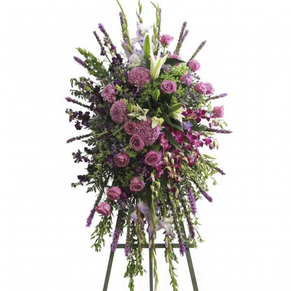 Tall standing floral spray with pink and purple flowers on an easel