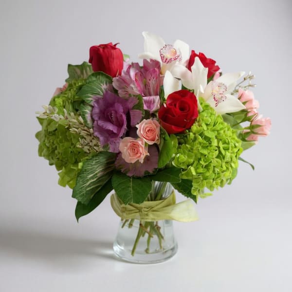 Bouquet of red, white, pink, and green flowers in a glass vase