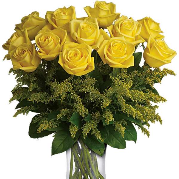 Yellow roses in a clear glass vase with green filler flowers