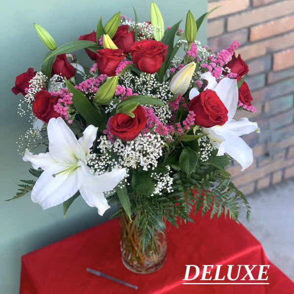 Red roses and white lilies in a clear glass vase