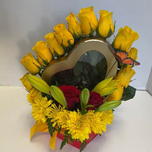 Heart-shaped floral arrangement with yellow roses, red roses, and yellow chrysanthemums