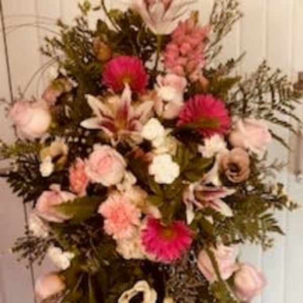 Tall pink and white floral standing spray on an easel