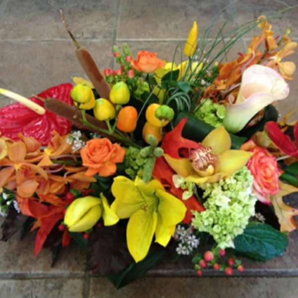 Colorful floral arrangement with calla lilies, roses, and orchids
